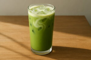 Healthy iced protein matcha latte in a tall glass with ice and frothy almond milk."Healthy iced protein matcha latte in a tall glass with ice and frothy almond milk, starbucks protein drink